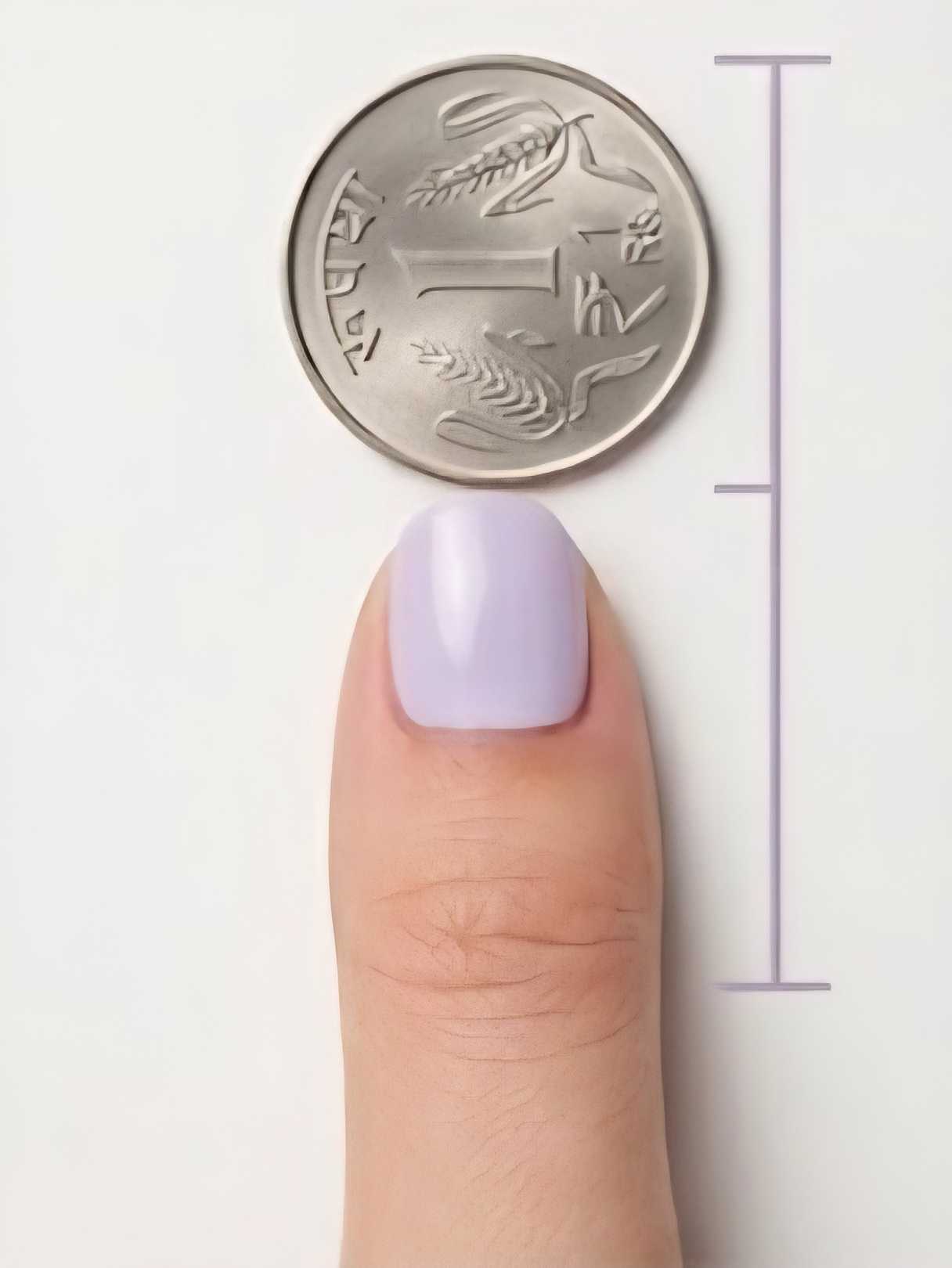 Right Thumb with ₹1 coin for nail sizing
